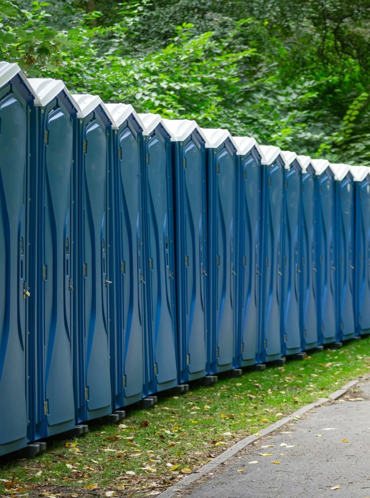 Bio public wc at a park. Locked, portable chemical lavatories. Nature background.